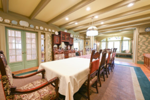 victorian-style dining room with long table and period chairs