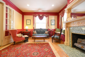 view of victorian-style seating by windows and window seat